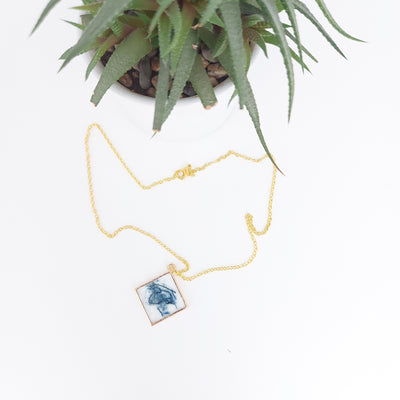 Square pendant necklace and jeans
