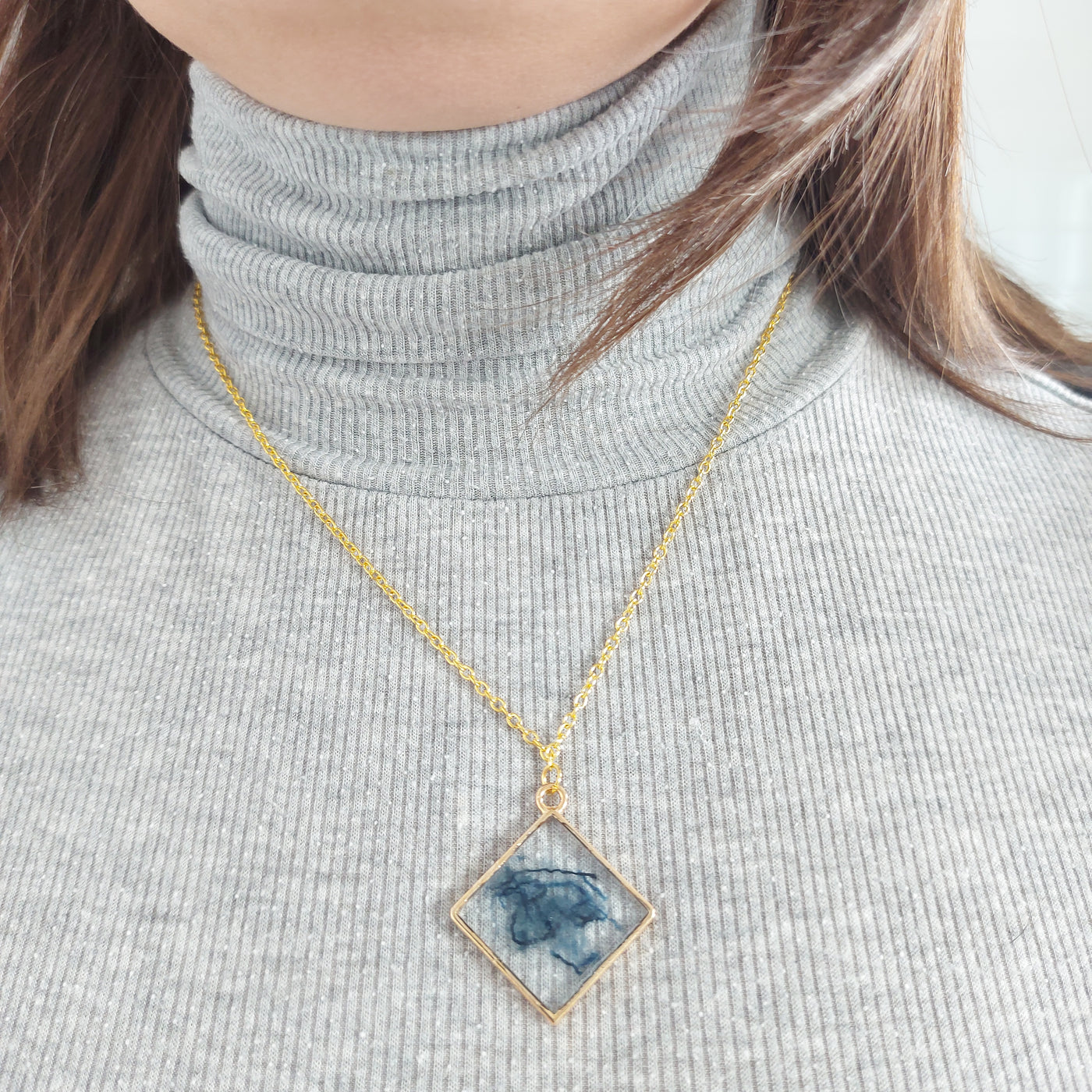 Square pendant necklace and jeans